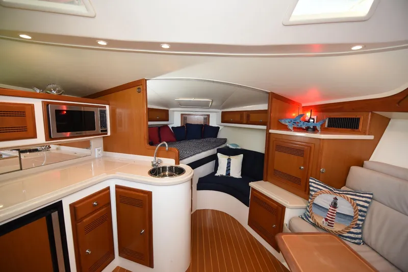 Slide: The Image of Luxurious interior of 2002 Cabo 35 Express yacht with modern amenities and cozy seating. - 68