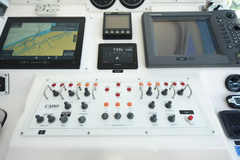 Slide: The Image of Control panel of a 2002 Cabo 35 Express boat with navigation and communication systems. - 54