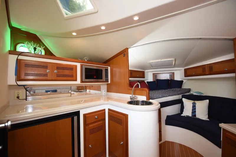 Slide: The Image of Luxurious interior of 2002 Cabo 35 Express yacht with kitchenette and cozy seating area. - 72