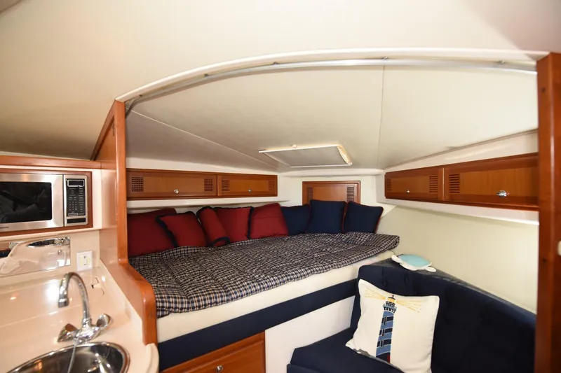 Slide: The Image of Interior of 2002 Cabo 35 Express boat with cozy bed and modern amenities. - 79