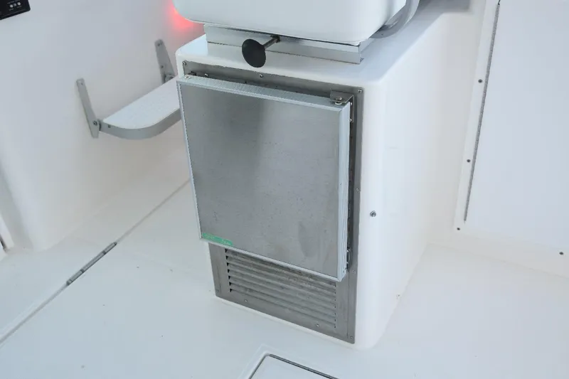 Slide: The Image of 2002 Cabo 35 Express boat interior with stainless steel appliance and white seating. - 50