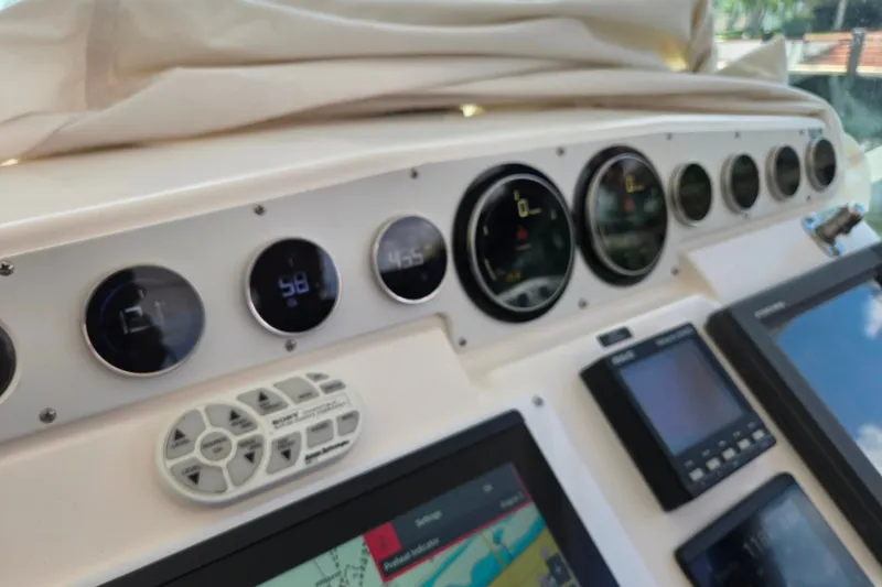 Slide: The Image of Dashboard of a 2002 Cabo 35 Express boat with gauges and navigation screens. - 63