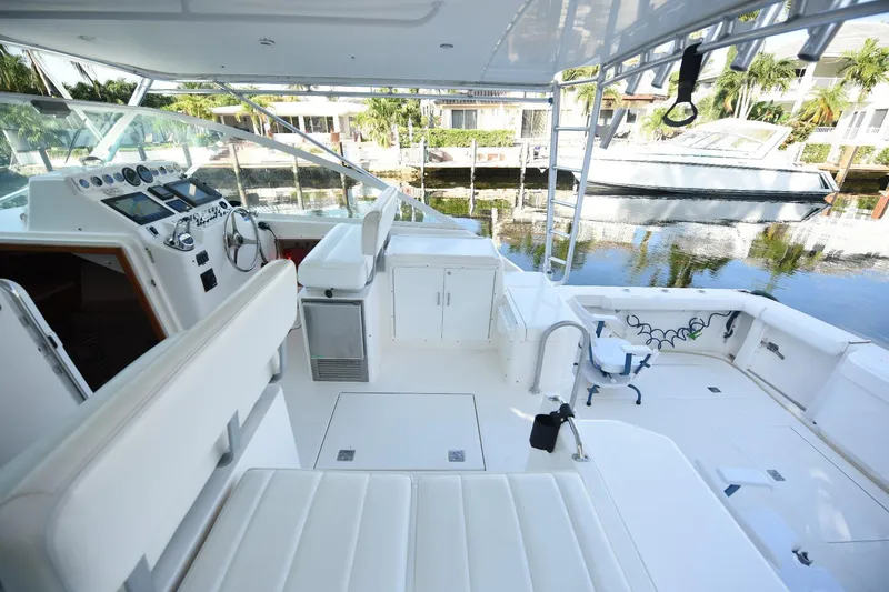 Slide: The Image of 2002 Cabo 35 Express yacht interior with helm, seating, and waterfront view. - 43