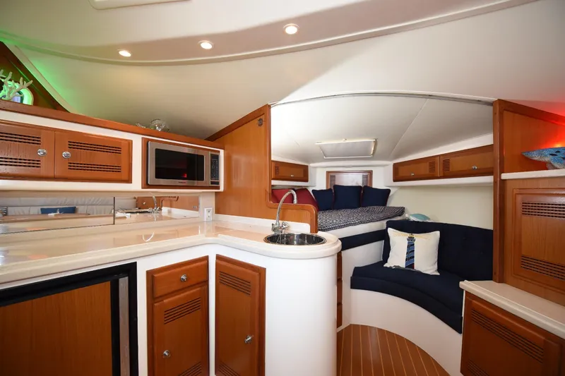 Slide: The Image of Luxurious interior of 2002 Cabo 35 Express yacht with modern kitchen and cozy seating area. - 73