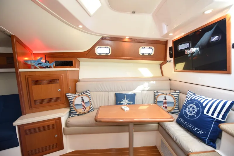 Slide: The Image of Interior of 2002 Cabo 35 Express yacht with cozy seating and nautical decor. - 82