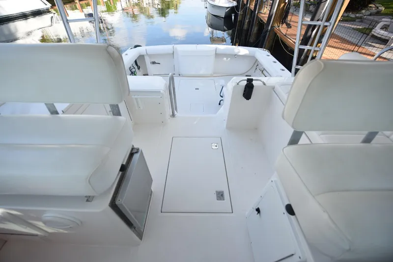 Slide: The Image of 2002 Cabo 35 Express boat interior with white seating and clean deck. - 51