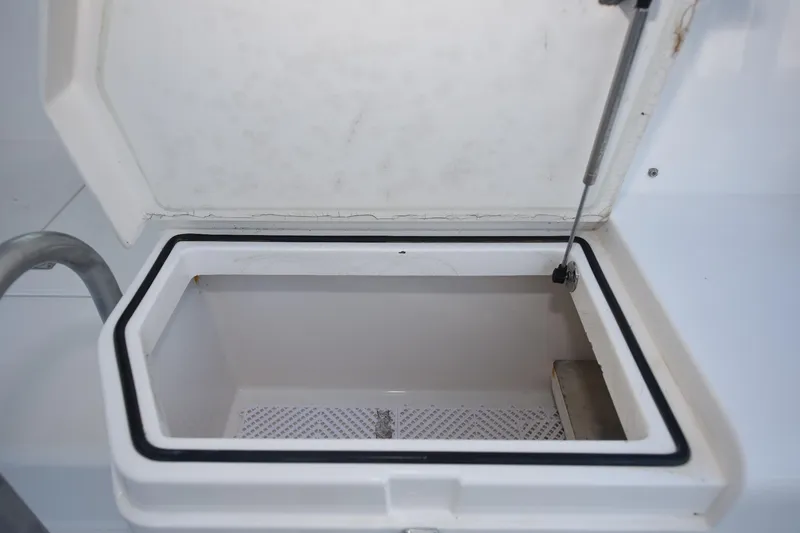 Slide: The Image of Open storage compartment on a 2002 Cabo 35 Express boat. - 28