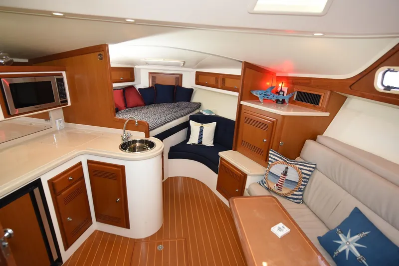 Slide: The Image of Interior of a 2002 Cabo 35 Express yacht with cozy seating and kitchenette. - 75