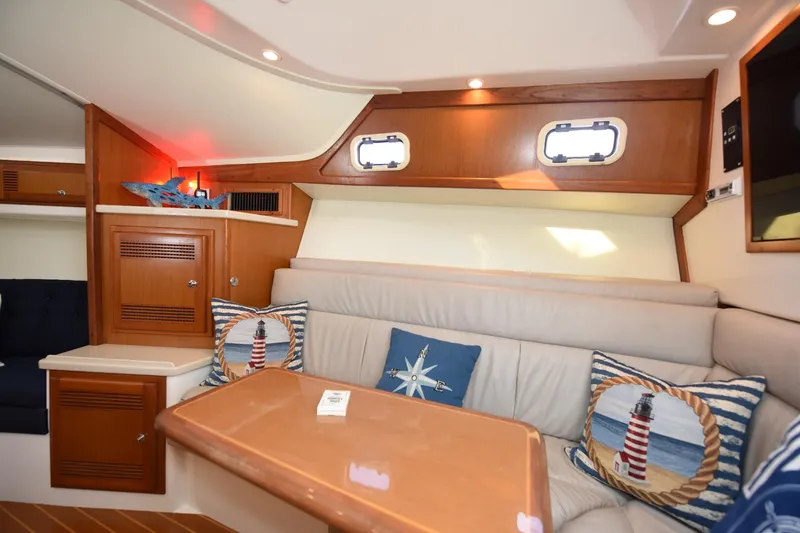 Slide: The Image of Interior of a 2002 Cabo 35 Express yacht with cozy seating and nautical decor. - 71
