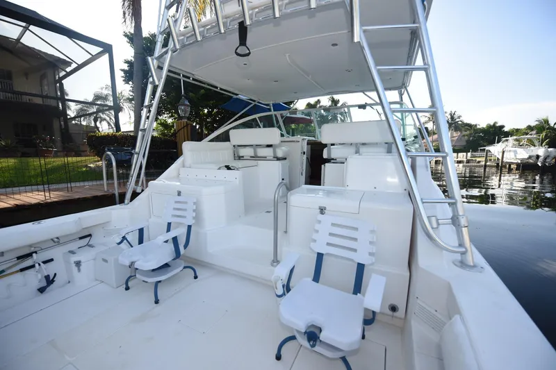Slide: The Image of 2002 Cabo 35 Express boat interior with seating and fishing equipment. - 16