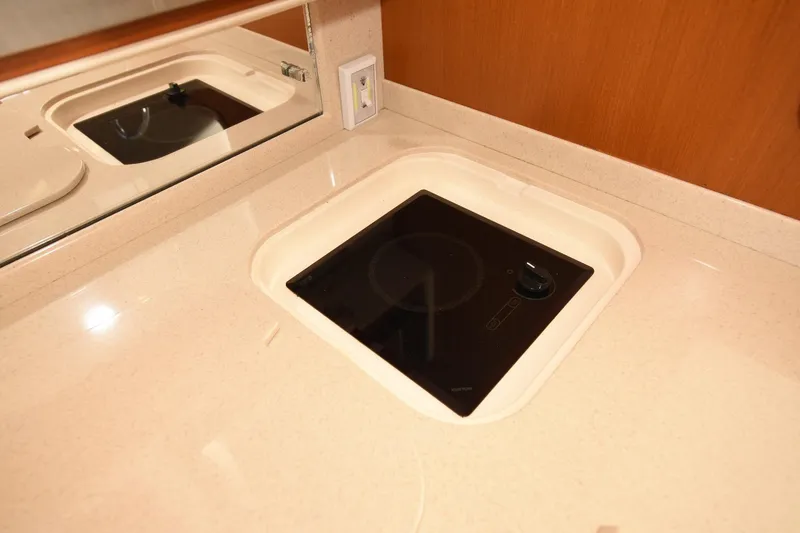 Slide: The Image of Built-in stovetop on 2002 Cabo 35 Express yacht's sleek kitchen counter. - 87
