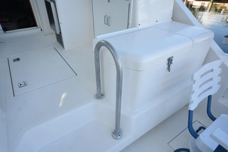 Slide: The Image of 2002 Cabo 35 Express boat deck with storage and seating area. - 45