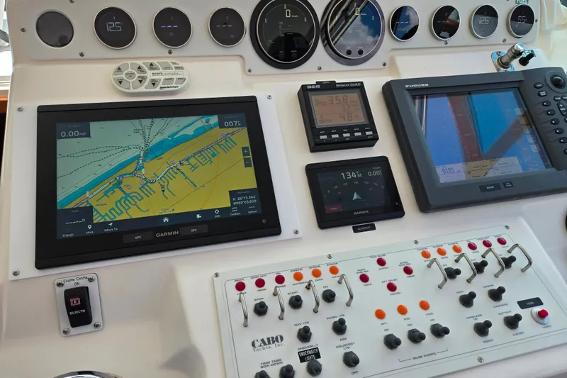 Slide: The Image of Control panel of a 2002 Cabo 35 Express boat with navigation and monitoring systems. - 55