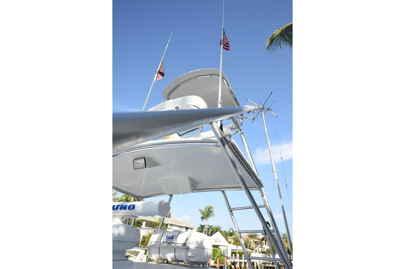 Slide: The Image of 2002 Cabo 35 Express boat with flags and antennas against a clear blue sky. - 41
