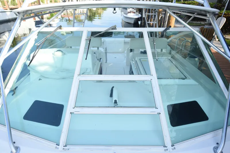 Slide: The Image of 2002 Cabo 35 Express boat with glass windshield and sleek design, docked at marina. - 39
