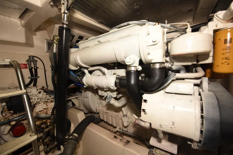 Slide: The Image of Engine room of a 2002 Cabo 35 Express boat, showcasing mechanical components and piping. - 101