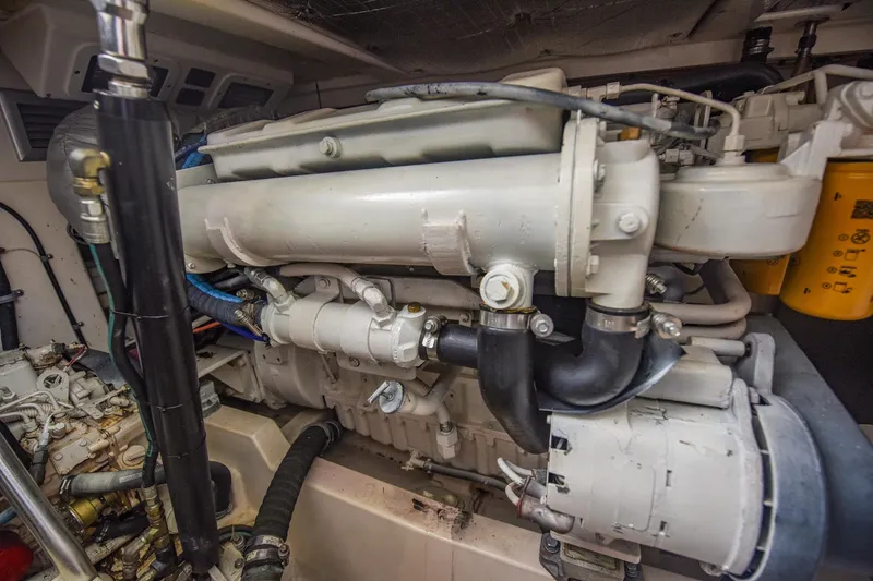 Slide: The Image of Engine compartment of a 2002 Cabo 35 Express boat, showcasing mechanical components. - 99