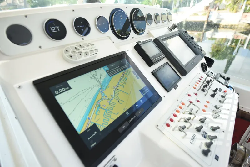 Slide: The Image of Control panel of a 2002 Cabo 35 Express boat with navigation screens and gauges. - 65