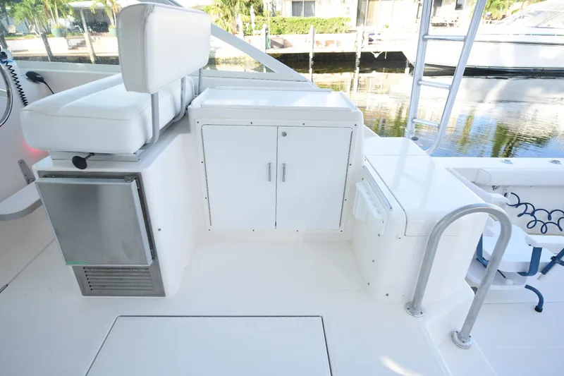 Slide: The Image of 2002 Cabo 35 Express boat interior with white seating and storage compartments. - 49