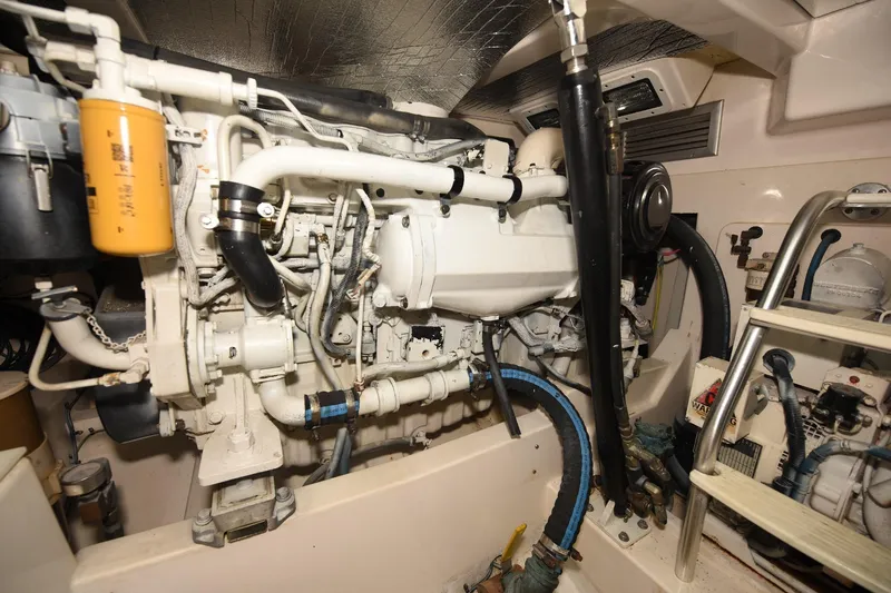 Slide: The Image of Engine room of a 2002 Cabo 35 Express boat, showcasing detailed machinery and components. - 102