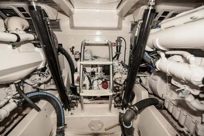 Slide: The Image of Engine room of a 2002 Cabo 35 Express boat, showcasing mechanical components and systems. - 103