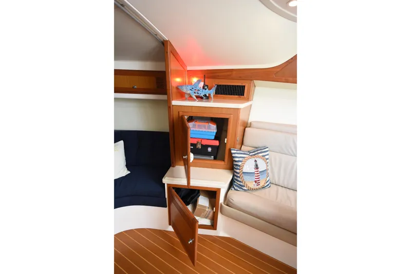 Slide: The Image of Interior of 2002 Cabo 35 Express boat with wooden cabinetry and nautical-themed decor. - 94