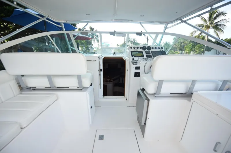 Slide: The Image of 2002 Cabo 35 Express boat interior with white seating and control panel. - 15