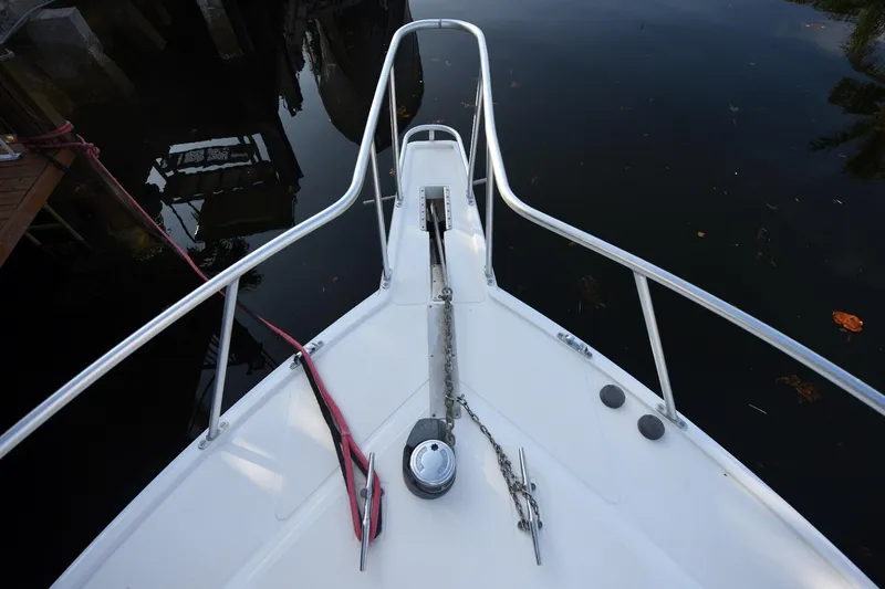 Slide: The Image of Bow view of 2002 Cabo 35 Express boat with anchor and railing. - 36