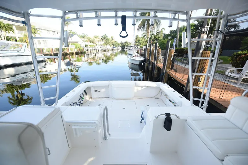 Slide: The Image of 2002 Cabo 35 Express boat docked in a serene canal setting. - 14