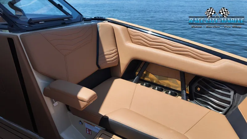 Slide: The Image of The image shows the interior of a 2027 Nautique G23 with beige leather seating. - 43