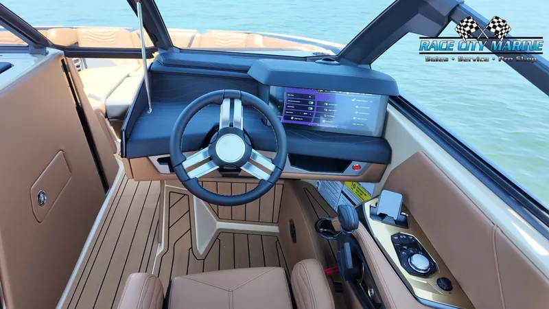 Slide: The Image of The image shows the cockpit of a 2027 Nautique G23 with a modern steering wheel and digital display. - 16