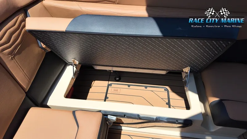 Slide: The Image of The image shows the storage area of a Nautique G23 boat with a seat lifted. - 42