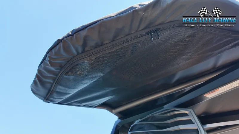 Slide: The Image of Close-up of a boat canopy with a zipper and mesh. The sky is clear and blue. - 37