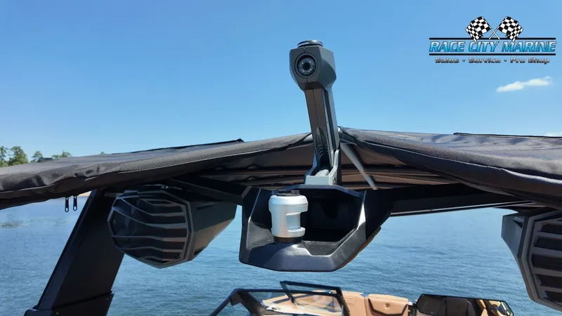 Slide: The Image of A modern boat with a black canopy and speakers, situated on calm waters. - 31
