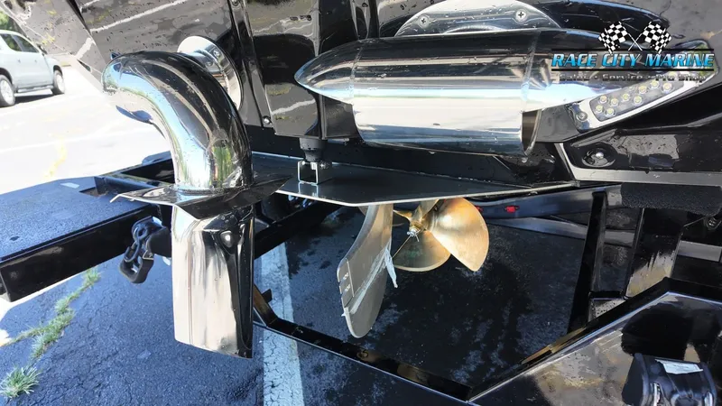 Slide: The Image of Close-up of a 2027 Nautique G23's drive with shiny propeller and exhaust. - 11