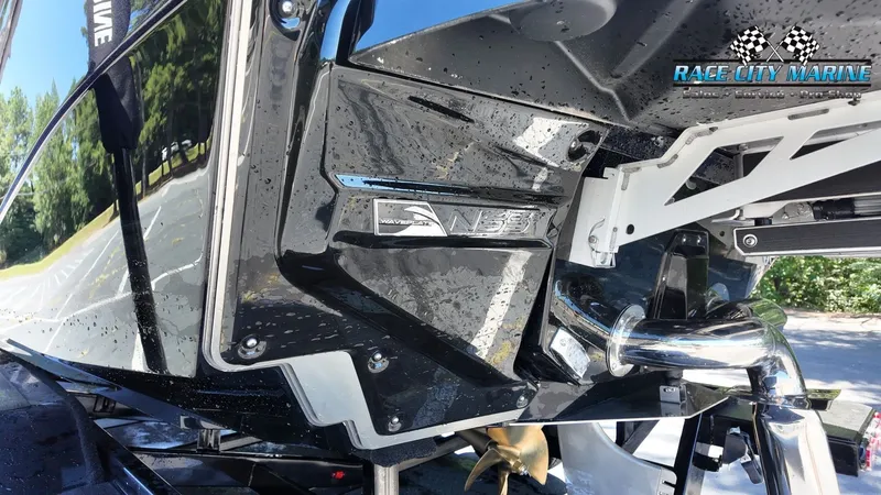 Slide: The Image of Close-up of the stern of a 2027 Nautique G23 boat with a glossy black finish. - 29