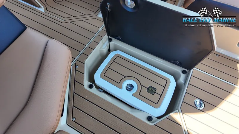 Slide: The Image of The image shows the interior of a 2027 Nautique G23 with an open storage compartment. - 23