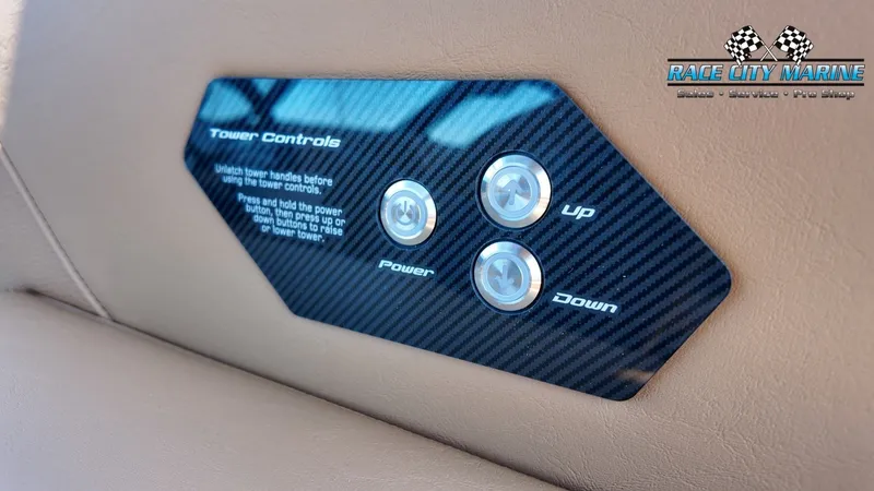Slide: The Image of Close-up of a 2027 Nautique G23 control panel with buttons for Power, Up, and Down. - 41