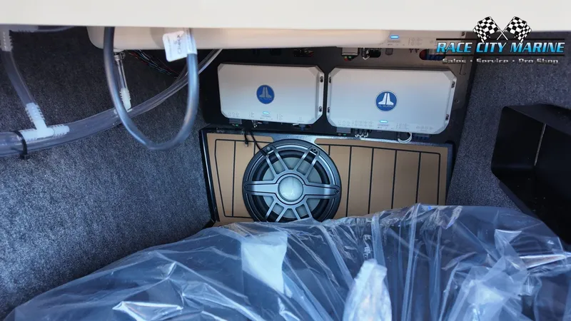 Slide: The Image of Interior view of a 2027 Nautique G23 featuring speakers and electronics. - 33