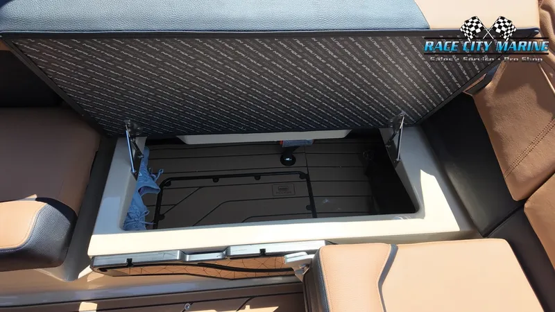 Slide: The Image of The image shows a storage compartment under a seat on a 2027 Nautique G23 boat. - 50