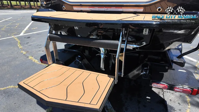 Slide: The Image of Rear view of a 2027 Nautique G23 with a fold-out swim platform. - 13