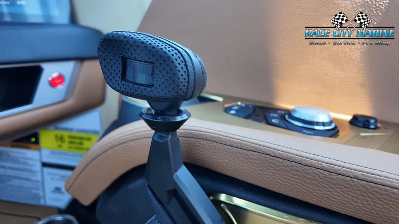 Slide: The Image of Close-up of a gear lever in a Nautique G23 boat, surrounded by brown leather and controls. - 30