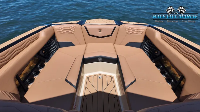 Slide: The Image of The image shows the bow area of a 2027 Nautique G23 boat with luxurious leather seating. - 48