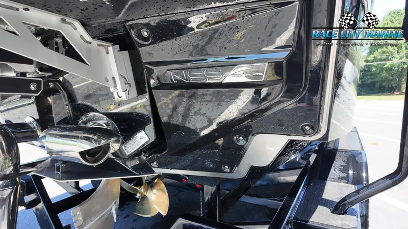 Slide: The Image of Close-up of a 2027 Nautique G23's stern with a shiny propeller and logo. - 10