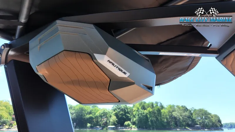 Slide: The Image of A speaker on a Nautique G23 boat, with trees in the background. - 40