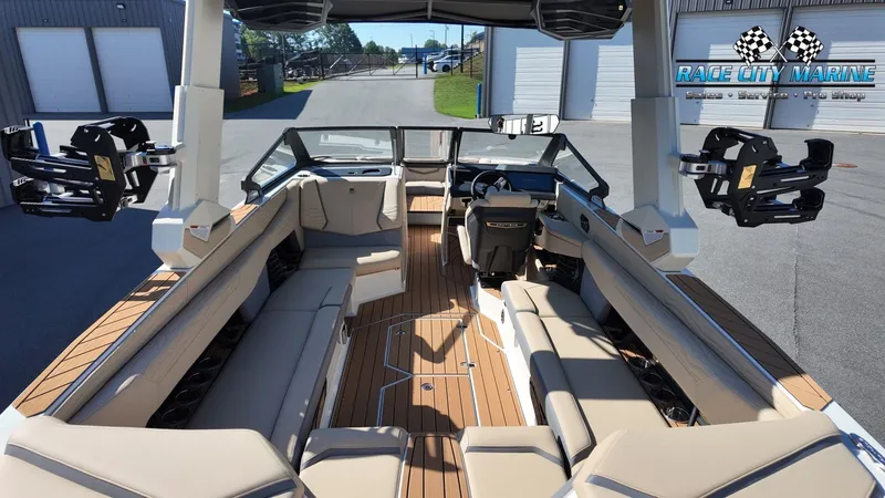 Slide: The Image of The image shows the interior of a 2027 Nautique G25 boat with sleek seating and modern design. - 25