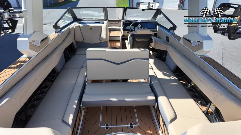 Slide: The Image of The image shows the interior of a 2027 Nautique G25 boat with luxurious seating and wood flooring. - 22