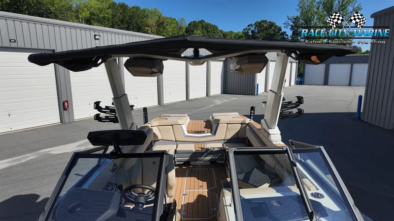Slide: The Image of The image shows a modern 2027 Nautique G25 boat with stylish interior and seating areas. - 34