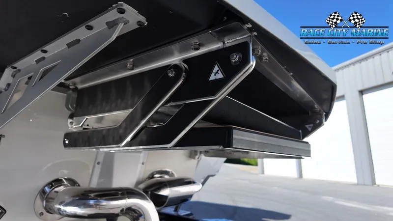 Slide: The Image of The image shows the stern of a Nautique G25 boat with a modern exhaust system. - 10