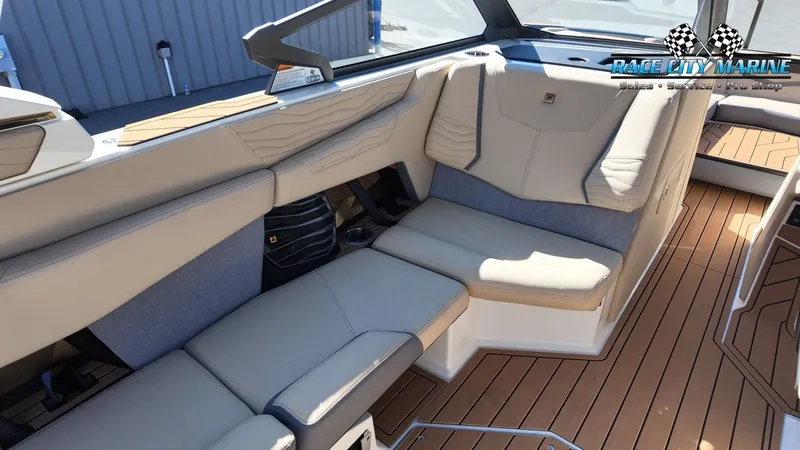 Slide: The Image of The image shows the luxurious interior of a Nautique G25 boat with sleek seating and wood flooring. - 23